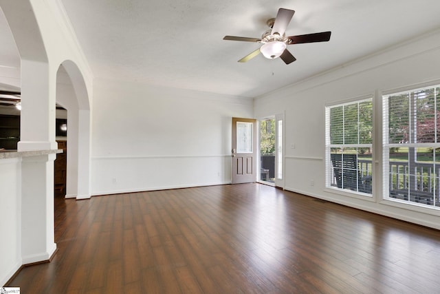 1893 Lake Cunningham Rd, Greer, SC 29651 - unfurnished living room with dark wood finished floors, a ceiling fan, ornamental molding, and arched walkways