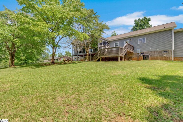 1893 Lake Cunningham Rd, Greer, SC 29651 - back of property featuring a sunroom, stairway, a lawn, and a deck
