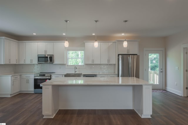 18003 Clermont Cir, Seneca, SC 29678 - kitchen featuring appliances with stainless steel finishes, a center island, decorative backsplash, white cabinetry, and dark wood-type flooring