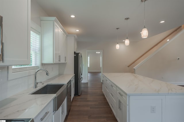 18003 Clermont Cir, Seneca, SC 29678 - kitchen featuring appliances with stainless steel finishes, tasteful backsplash, a kitchen island, dark wood-style floors, and white cabinetry