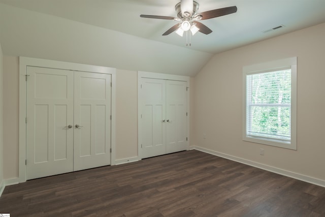 18003 Clermont Cir, Seneca, SC 29678 - unfurnished bedroom featuring multiple closets, lofted ceiling, dark wood-type flooring, and a ceiling fan