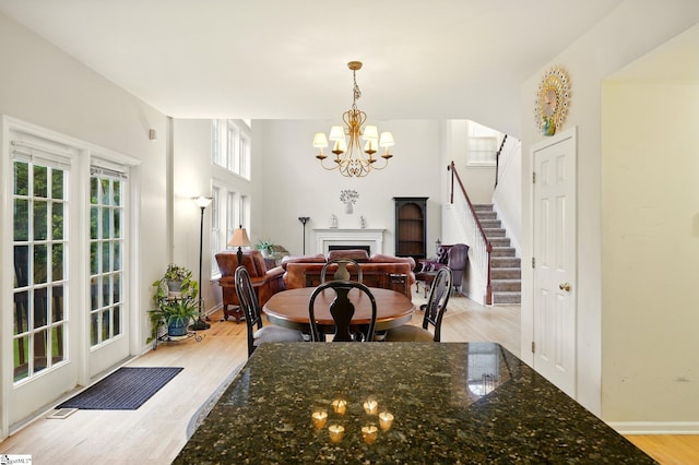 108 Myrtle Way, Greer, SC 29650 - dining room with a chandelier, stairs, light wood finished floors, and a fireplace