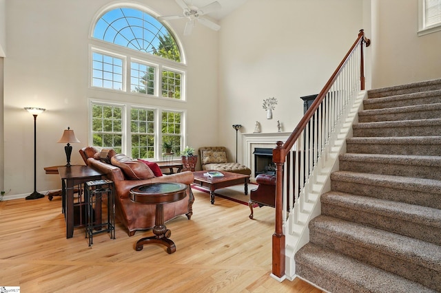 108 Myrtle Way, Greer, SC 29650 - living room featuring a high ceiling, healthy amount of natural light, stairs, a fireplace, and light wood-style flooring