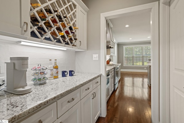203 Piper Glen Ln, Inman, SC 29349 - bar featuring stainless steel gas stove, tasteful backsplash, dark wood finished floors, and recessed lighting
