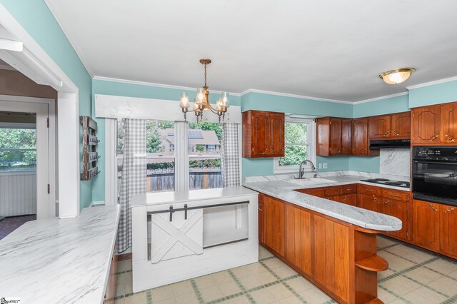 106 Thackston St, Fountain Inn, SC 29644 - kitchen with black oven, a chandelier, a peninsula, ventilation hood, and hanging light fixtures