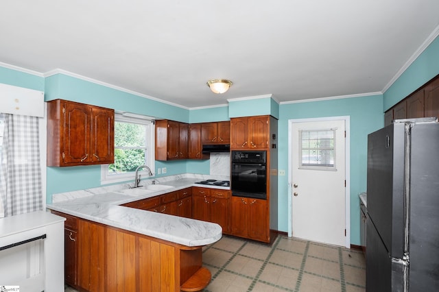 106 Thackston St, Fountain Inn, SC 29644 - kitchen with freestanding refrigerator, black oven, electric cooktop, light floors, and a peninsula
