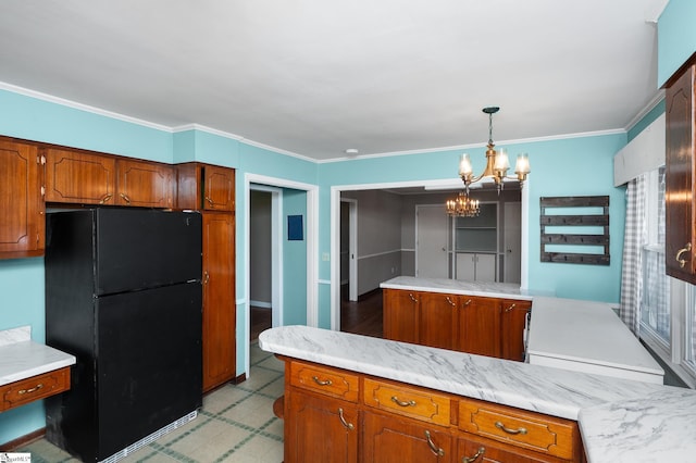 106 Thackston St, Fountain Inn, SC 29644 - kitchen featuring freestanding refrigerator, a chandelier, light countertops, brown cabinets, and ornamental molding