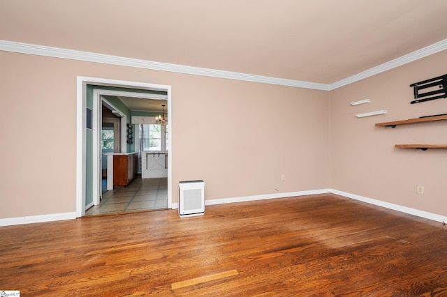 106 Thackston St, Fountain Inn, SC 29644 - spare room featuring wood finished floors, ornamental molding, and a chandelier