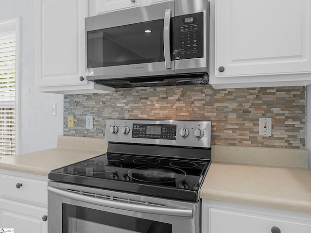 68 Arbours W Ln, Moore, SC 29369 - kitchen featuring appliances with stainless steel finishes, light countertops, white cabinets, and decorative backsplash