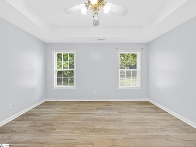68 Arbours W Ln, Moore, SC 29369 - empty room with a tray ceiling, plenty of natural light, and light wood-style flooring