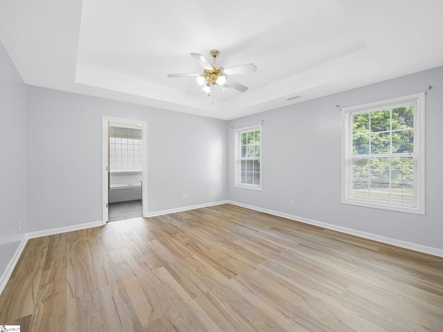 68 Arbours W Ln, Moore, SC 29369 - spare room featuring a tray ceiling, ceiling fan, and light wood-style floors