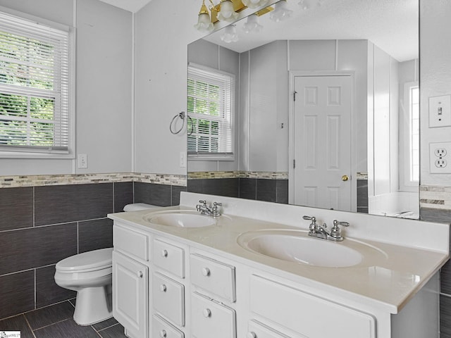 68 Arbours W Ln, Moore, SC 29369 - full bathroom featuring tile walls, double vanity, healthy amount of natural light, tile patterned floors, and wainscoting
