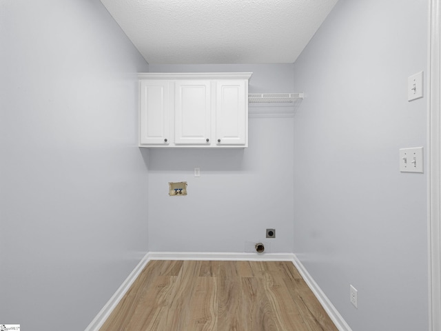 68 Arbours W Ln, Moore, SC 29369 - washroom featuring hookup for a washing machine, light wood-style floors, electric dryer hookup, cabinet space, and a textured ceiling