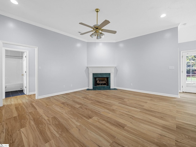 68 Arbours W Ln, Moore, SC 29369 - unfurnished living room featuring a ceiling fan, light wood-style flooring, ornamental molding, recessed lighting, and a tiled fireplace