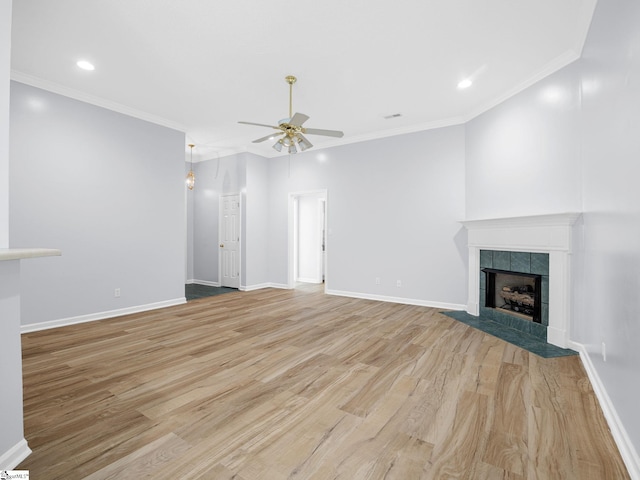 68 Arbours W Ln, Moore, SC 29369 - unfurnished living room with a ceiling fan, light wood-style floors, a tiled fireplace, recessed lighting, and ornamental molding