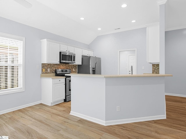 68 Arbours W Ln, Moore, SC 29369 - kitchen featuring appliances with stainless steel finishes, decorative backsplash, white cabinets, light wood-style flooring, and vaulted ceiling