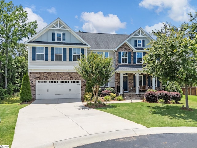 711 Hatwood Ct, Duncan, SC 29334 - craftsman-style home featuring concrete driveway, stone siding, an attached garage, a porch, and a front yard