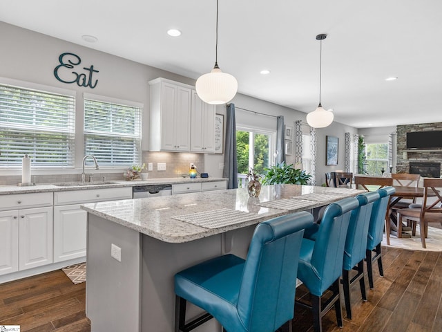 711 Hatwood Ct, Duncan, SC 29334 - kitchen featuring a kitchen bar, dark wood-style flooring, a kitchen island, white cabinetry, and recessed lighting