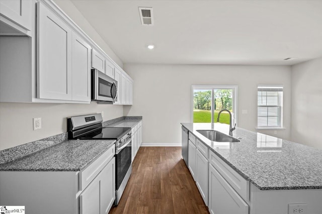 217 Islay Way, Anderson, SC 29621 - kitchen with appliances with stainless steel finishes, an island with sink, dark wood-style flooring, white cabinets, and light stone counters