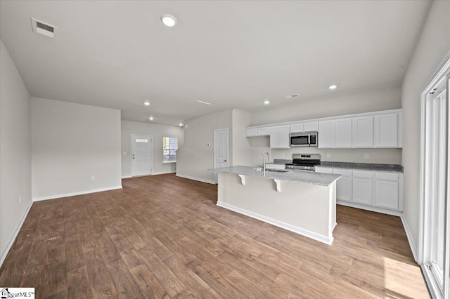 217 Islay Way, Anderson, SC 29621 - kitchen featuring stainless steel appliances, white cabinets, wood finished floors, recessed lighting, and a kitchen island with sink
