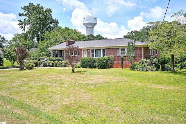 204 Jasper St, Easley, SC 29640 - view of front facade with a front yard, brick siding, and a chimney