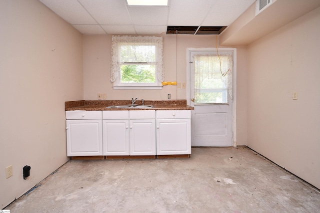 204 Jasper St, Easley, SC 29640 - kitchen with white cabinets, dark countertops, concrete flooring, and a drop ceiling