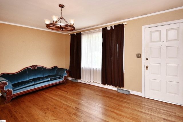204 Jasper St, Easley, SC 29640 - unfurnished living room featuring a chandelier, light wood finished floors, and crown molding