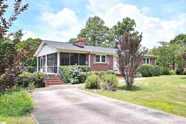 204 Jasper St, Easley, SC 29640 - single story home featuring a sunroom, brick siding, a front lawn, and a chimney