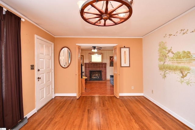 204 Jasper St, Easley, SC 29640 - unfurnished living room featuring light wood finished floors, a brick fireplace, a baseboard heating unit, ceiling fan, and crown molding
