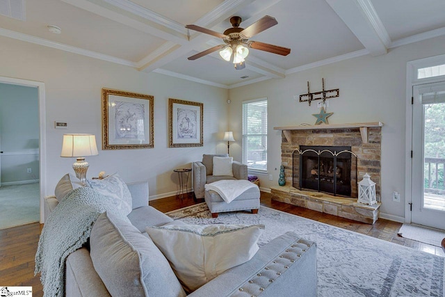 104 Saddlehorn Ln, Easley, SC 29642 - living room featuring beamed ceiling, wood finished floors, a ceiling fan, a stone fireplace, and crown molding