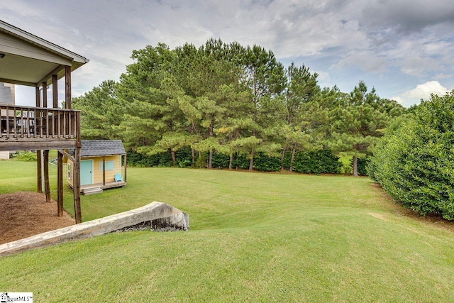 104 Saddlehorn Ln, Easley, SC 29642 - view of green lawn with an outbuilding, a wooden deck, and view of wooded area