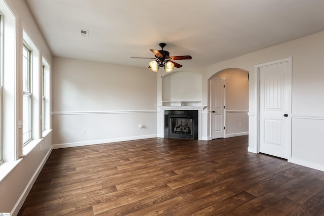319 Aniken Cir, Boiling Springs, SC 29316 - unfurnished living room with a ceiling fan, dark wood-style floors, a fireplace, and arched walkways