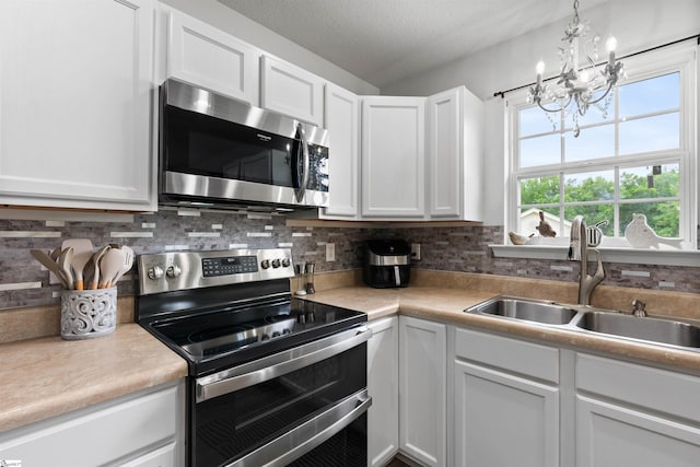 640 Slippery Moss Dr, Spartanburg, SC 29303 - kitchen with appliances with stainless steel finishes, a chandelier, white cabinetry, light countertops, and a textured ceiling