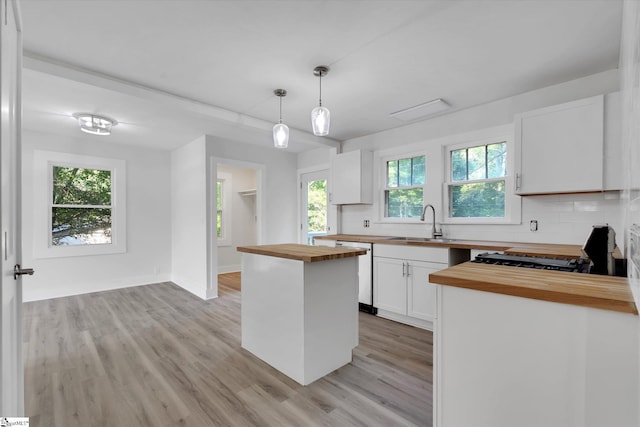 721 Central St, Iva, SC 29655 - kitchen featuring butcher block countertops, dishwasher, light wood finished floors, white cabinetry, and decorative backsplash