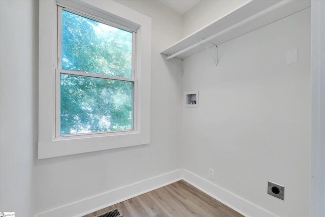 721 Central St, Iva, SC 29655 - laundry area with electric dryer hookup, hookup for a washing machine, light wood-type flooring, and healthy amount of natural light