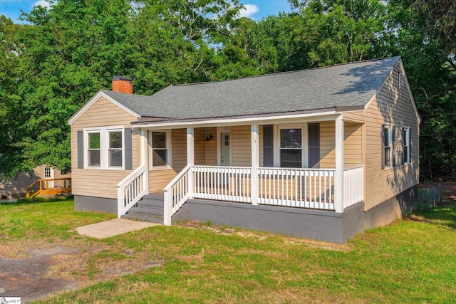 721 Central St, Iva, SC 29655 - bungalow featuring covered porch, a chimney, a shingled roof, and a front lawn