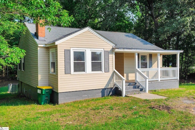 721 Central St, Iva, SC 29655 - bungalow featuring covered porch, a front lawn, a shingled roof, and a chimney