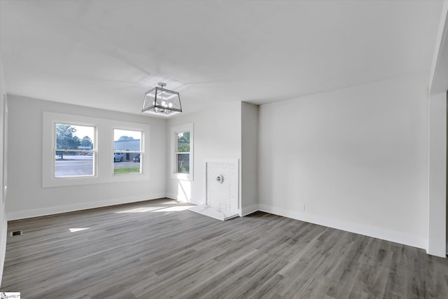 721 Central St, Iva, SC 29655 - unfurnished living room featuring a chandelier, wood finished floors, and healthy amount of natural light