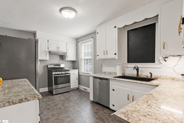 2608 Lane Ave, Anderson, SC 29621 - kitchen featuring appliances with stainless steel finishes, white cabinets, tasteful backsplash, and light countertops