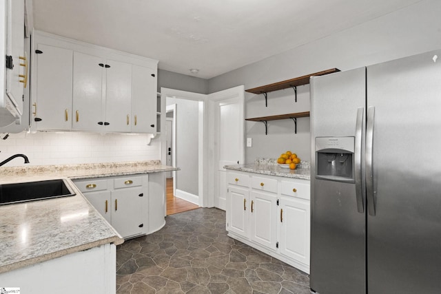 2608 Lane Ave, Anderson, SC 29621 - kitchen featuring stainless steel refrigerator with ice dispenser, open shelves, white cabinetry, and decorative backsplash