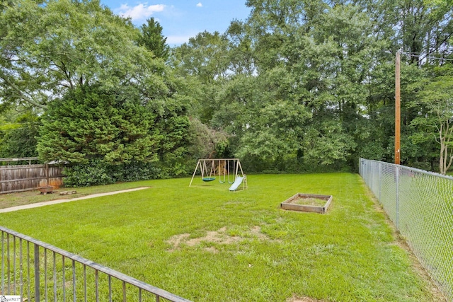 2608 Lane Ave, Anderson, SC 29621 - fenced backyard featuring a playground and a vegetable garden