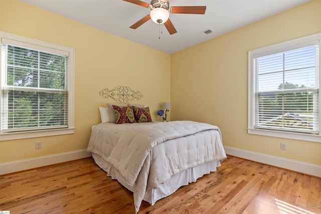 19 Merritt View Ter, Greenville, SC 29609 - bedroom featuring multiple windows, wood finished floors, and ceiling fan