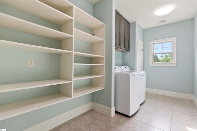 19 Merritt View Ter, Greenville, SC 29609 - laundry area with washing machine and dryer, light tile patterned flooring, and cabinet space