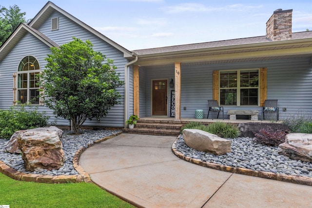 19 Merritt View Ter, Greenville, SC 29609 - view of front of home with covered porch, a chimney, and a shingled roof
