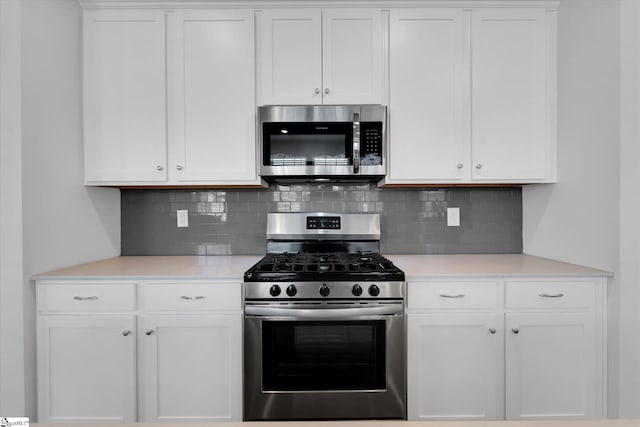 14 Gaskins Trl, Travelers Rest, SC 29690 - kitchen featuring stainless steel appliances, decorative backsplash, light countertops, and white cabinetry