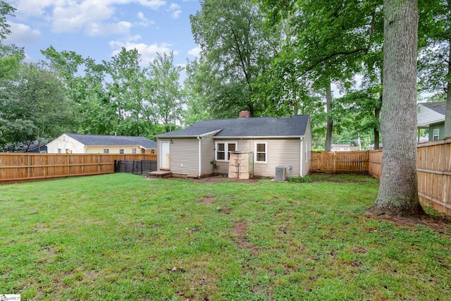 509 Montague St, Anderson, SC 29624 - back of house featuring a fenced backyard, a chimney, and view of wooded area