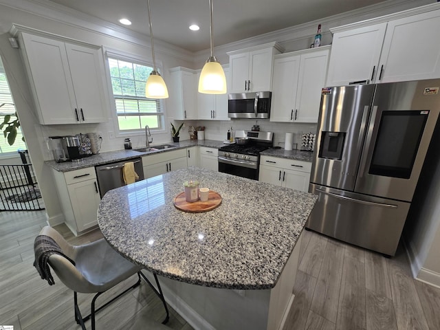 406 Willow Grove Way, Anderson, SC 29631 - kitchen with stainless steel appliances, a kitchen island, white cabinetry, tasteful backsplash, and ornamental molding