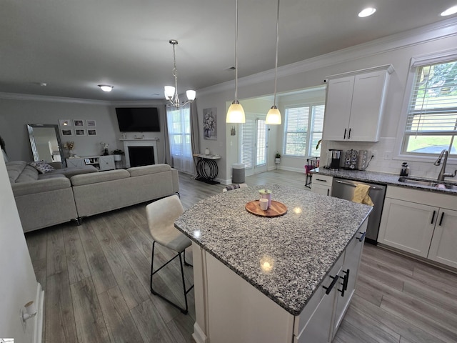406 Willow Grove Way, Anderson, SC 29631 - kitchen with stainless steel dishwasher, ornamental molding, a kitchen island, white cabinetry, and wood finished floors