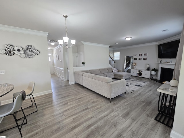 406 Willow Grove Way, Anderson, SC 29631 - living area featuring crown molding, light wood-style floors, a chandelier, a fireplace, and stairway
