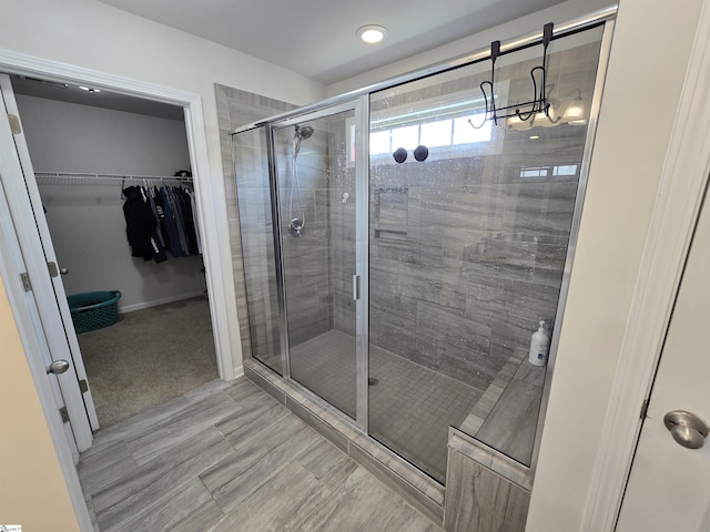 406 Willow Grove Way, Anderson, SC 29631 - bathroom featuring a stall shower, a walk in closet, and a chandelier